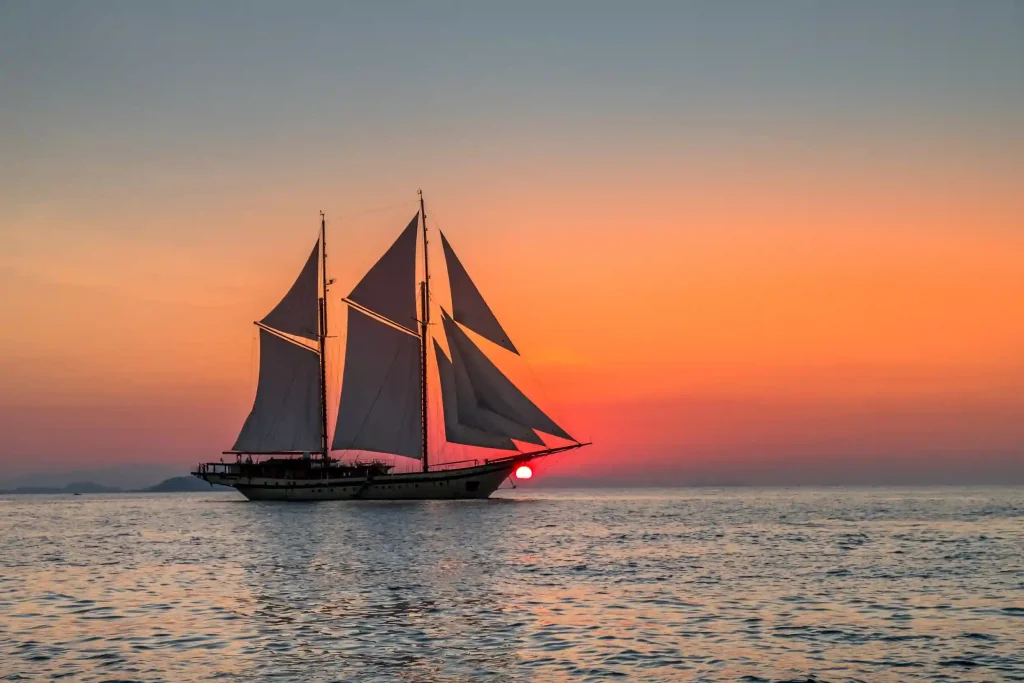 Phinisi silhouetted at sunset in Komodo